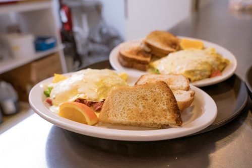 breakfast menu items at Raphael's that include an omlete toast and orange slices